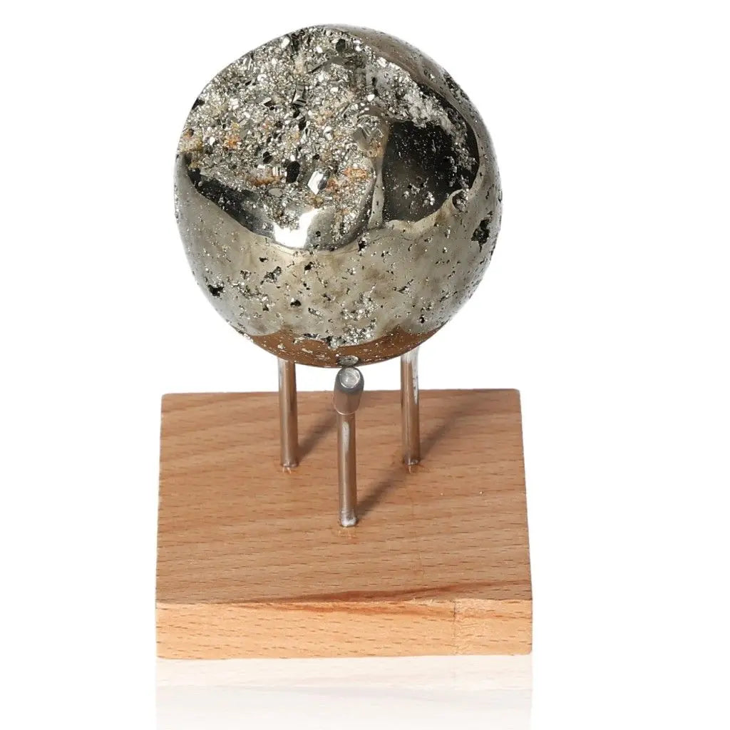 Pyrite sphere on wooden stand, showcasing golden metallic luster, symbol of abundance and prosperity, also known as Fool's Gold.