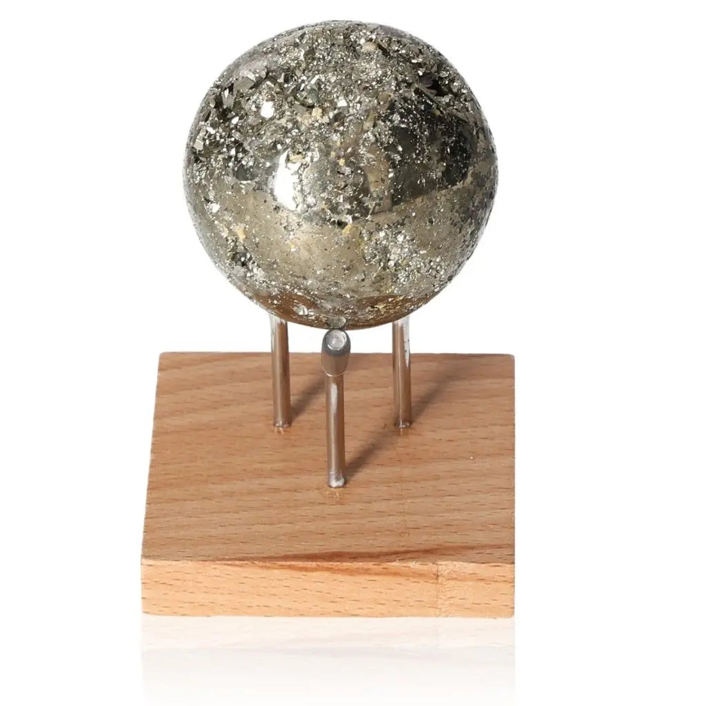 Pyrite sphere on wooden stand, showcasing its radiant golden hue and metallic luster, symbolizing abundance and prosperity.