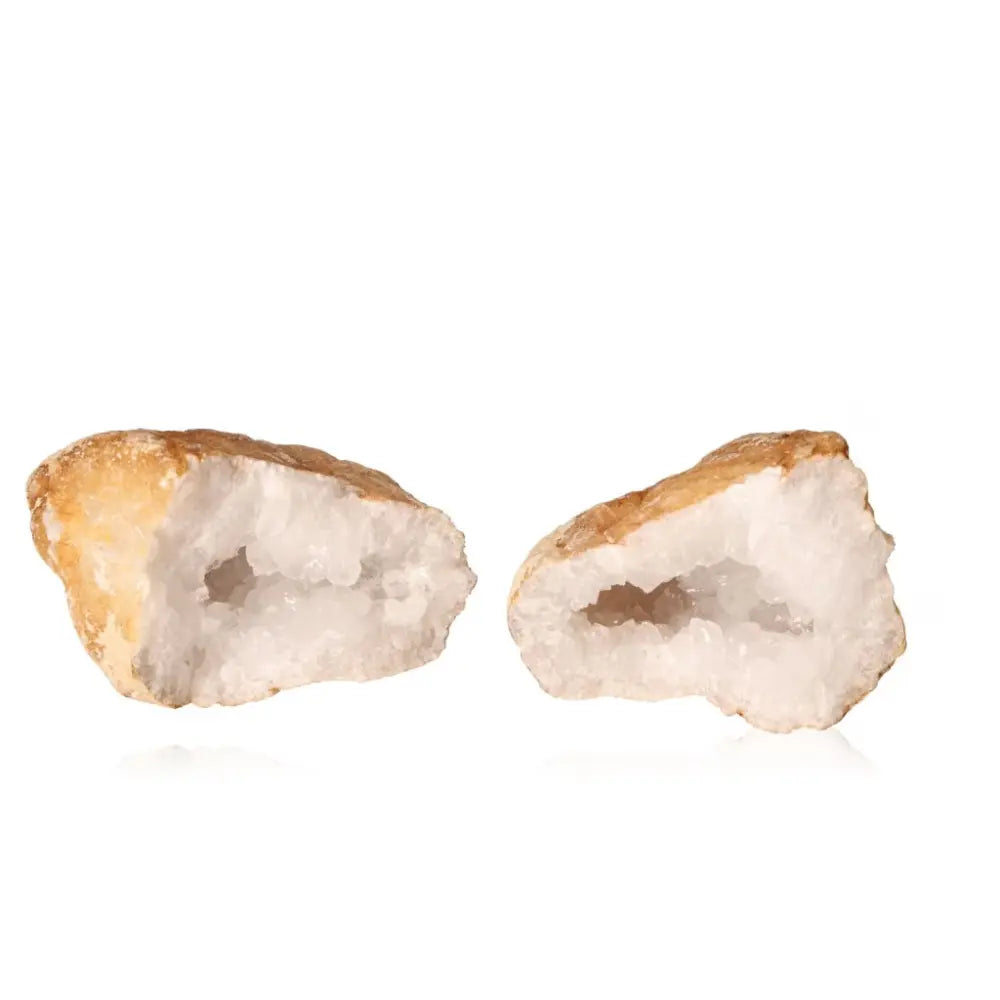 Quartz geode split open displaying sparkling crystals inside, showcasing its earthy exterior and natural geological beauty.