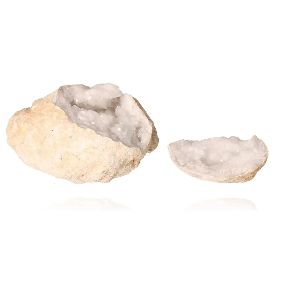 Quartz geode split open, revealing sparkling milky white crystals, known for amplifying energy and enhancing tranquility.