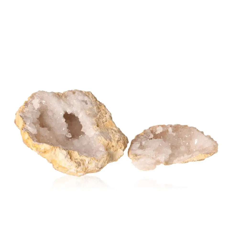 Milky quartz geode revealing sparkling white crystals, known for purifying energy and enhancing tranquility and clarity.