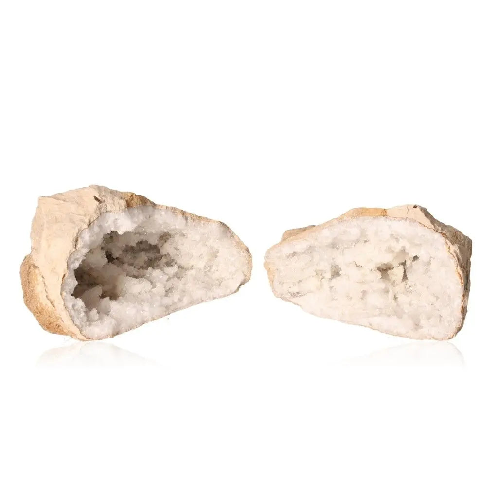 Quartz geode split open revealing sparkling white crystals, showcasing natural beauty and artistry.