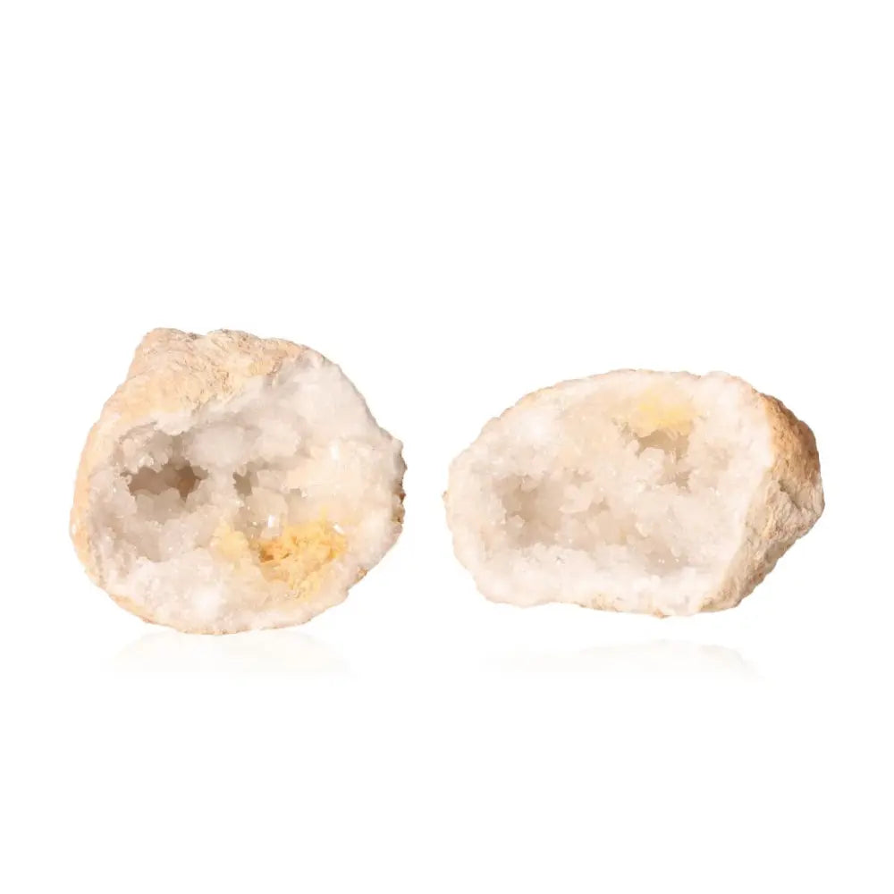 Open quartz geode displaying sparkling white crystals and rugged exterior.
