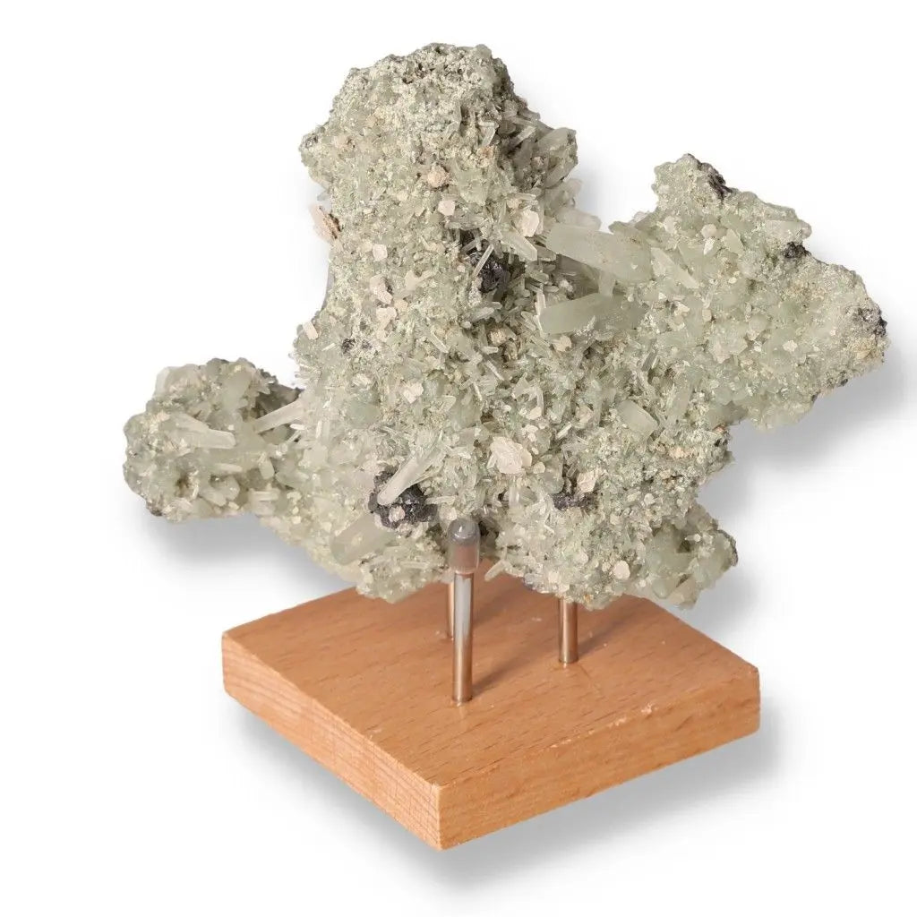 Natural quartz crystal cluster on a wooden display stand, highlighting its unique texture and healing properties.