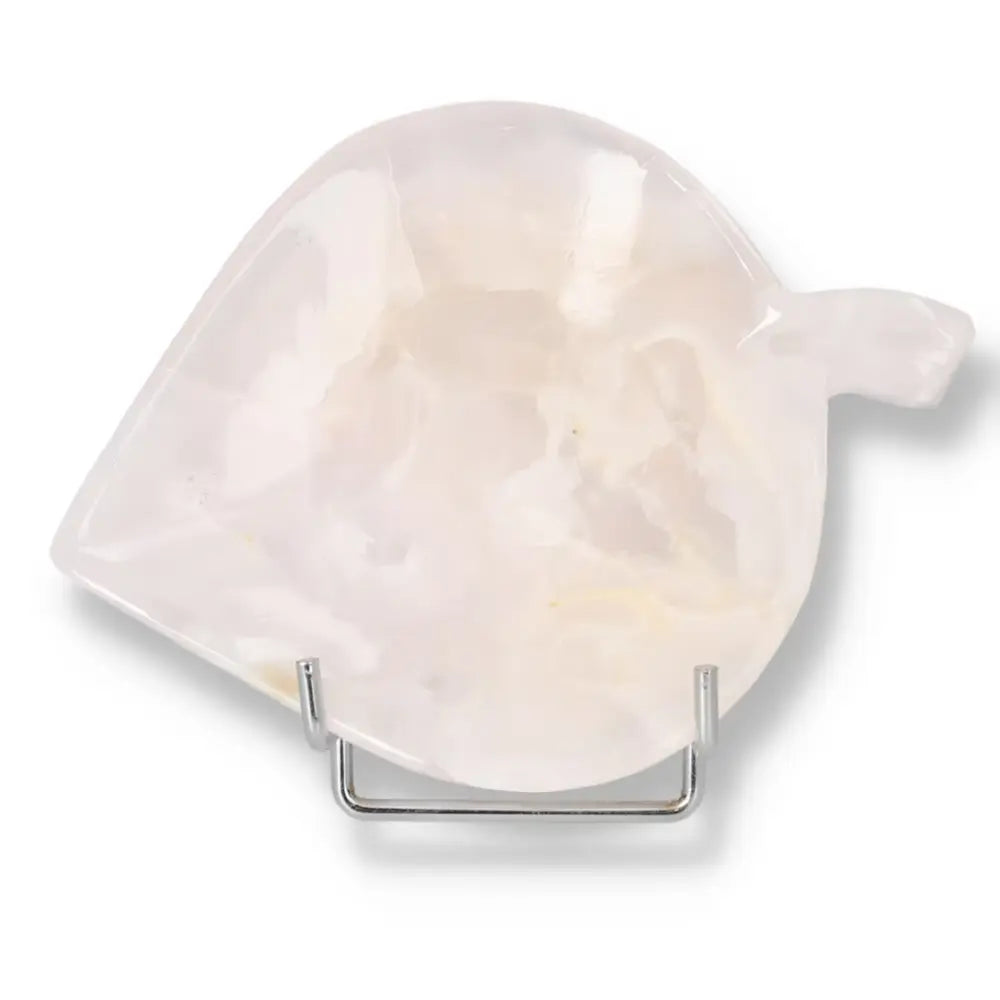 Rose onyx platter with unique veining on a display stand, showcasing polished surface and warm hues.