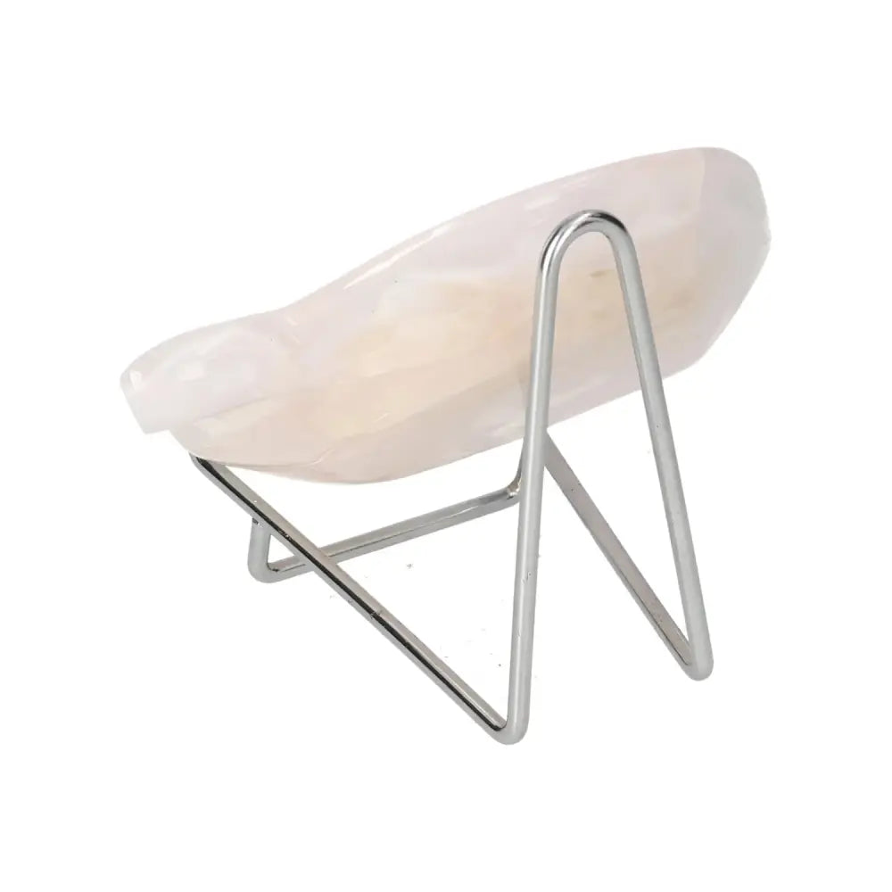 Rose onyx platter with unique veining on modern metal stand, showcasing elegant craftsmanship and natural beauty.