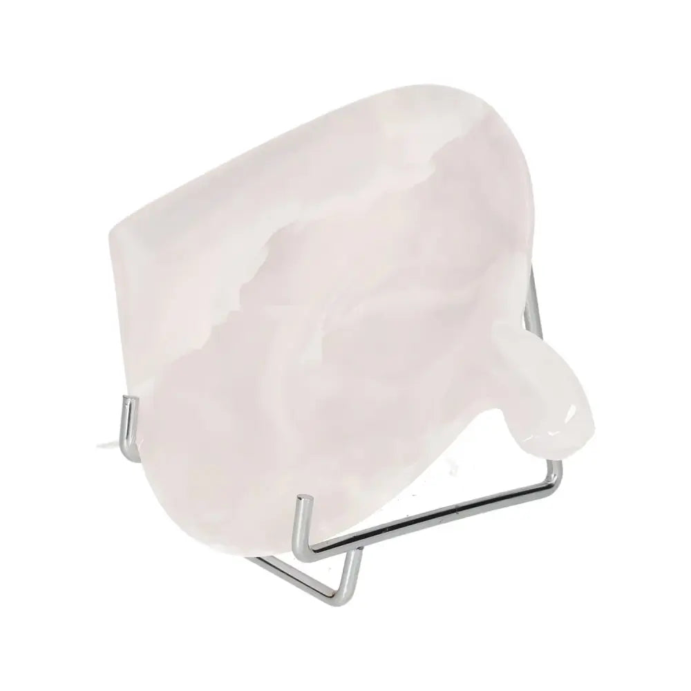 Rose onyx platter with unique veining and polished finish on a metal stand, showcasing its elegant, natural beauty and warm tones.
