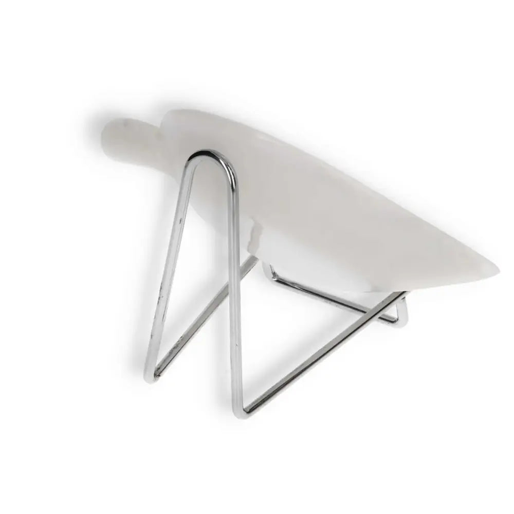 Porcelain serving dish supported by a modern chrome stand, viewed from the side, highlighting sleek design and white ceramic finish.