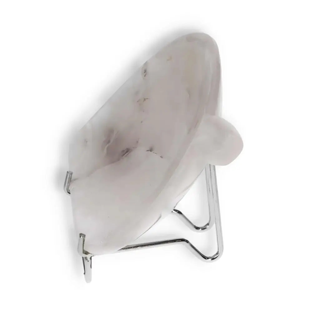 Side view of a rose onyx platter on a metal stand, showcasing its elegant veining and polished finish.