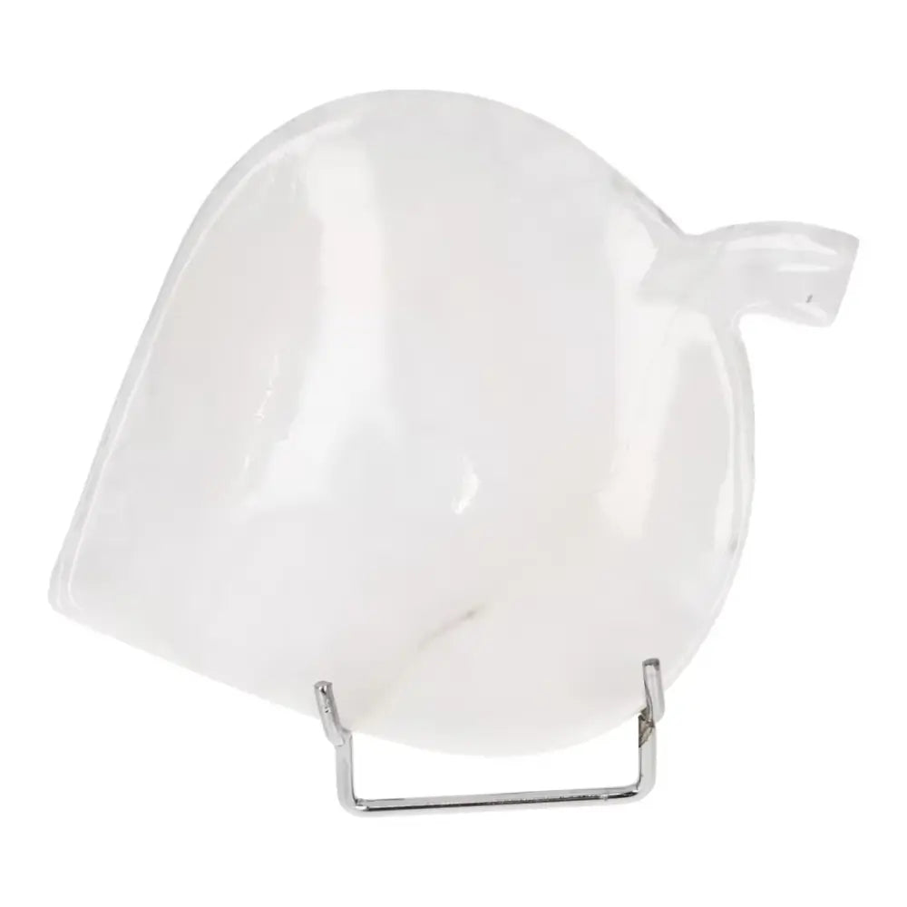 Heart-shaped white onyx platter on a stand, showcasing polished surface and unique veining, perfect for serving or as elegant decor.