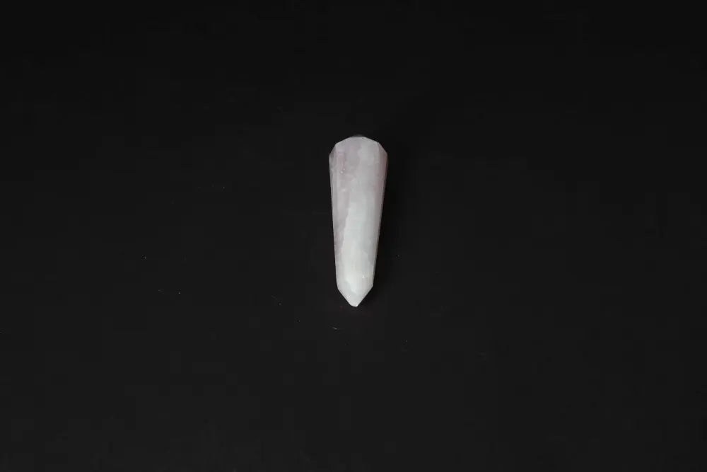 Rose Quartz Point on black background, ideal for love and heart chakra energy healing.
