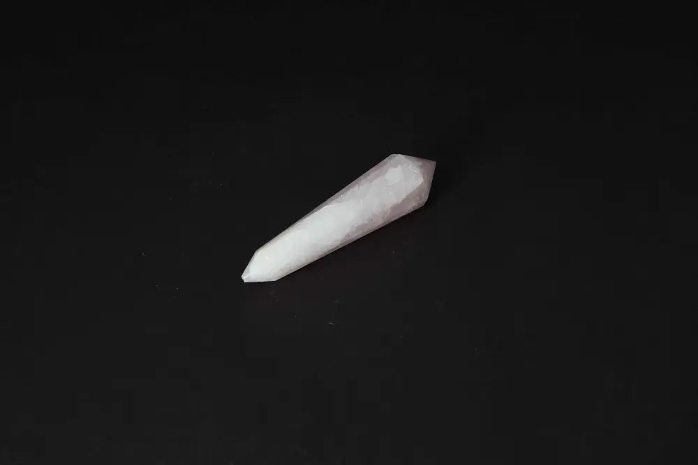 Rose Quartz Point crystal for love and healing on a dark background, used for emotional balance and heart chakra work.