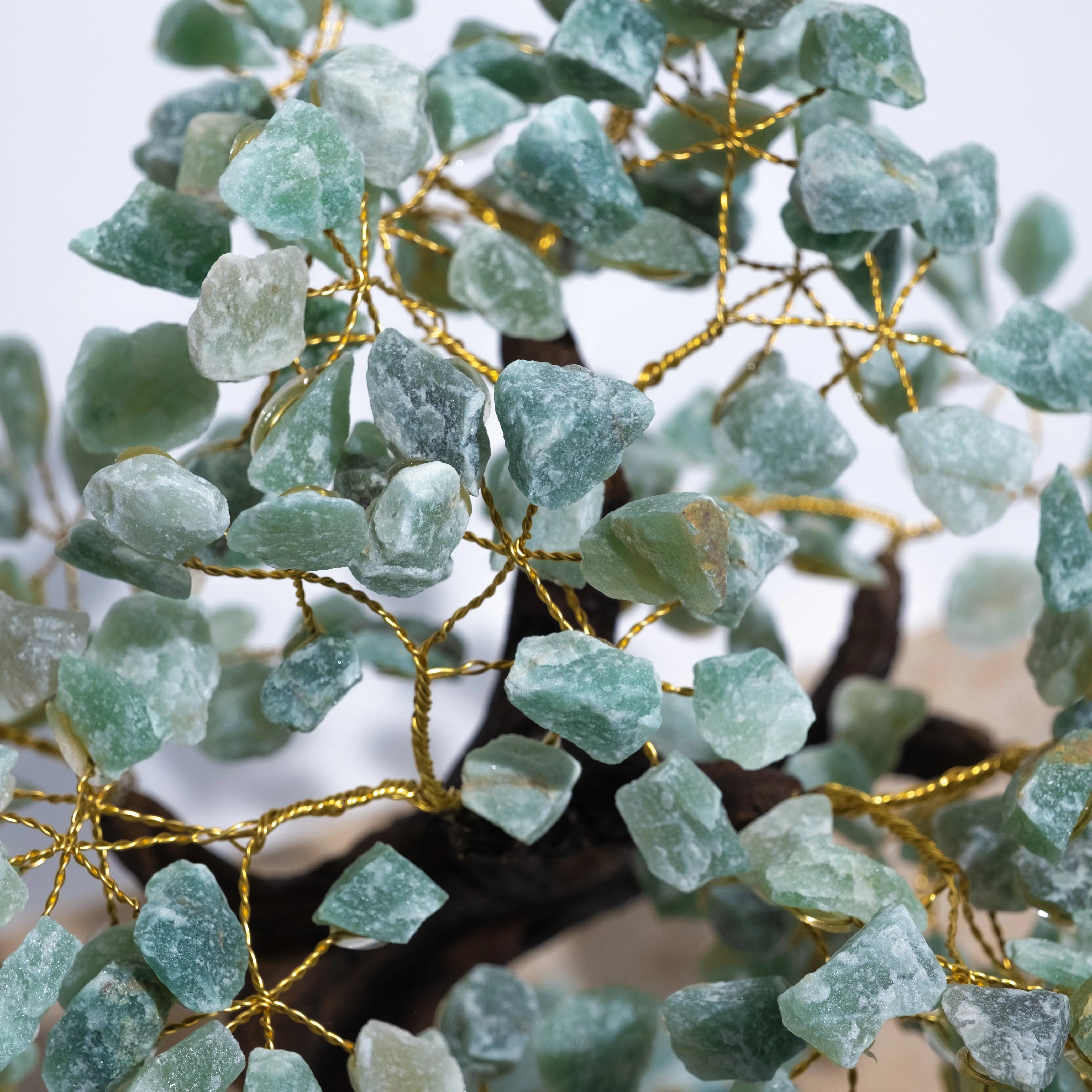 Close-up of Aventurine Crystal Bonsai Tree with green stones and gold wire symbolizing growth and prosperity.