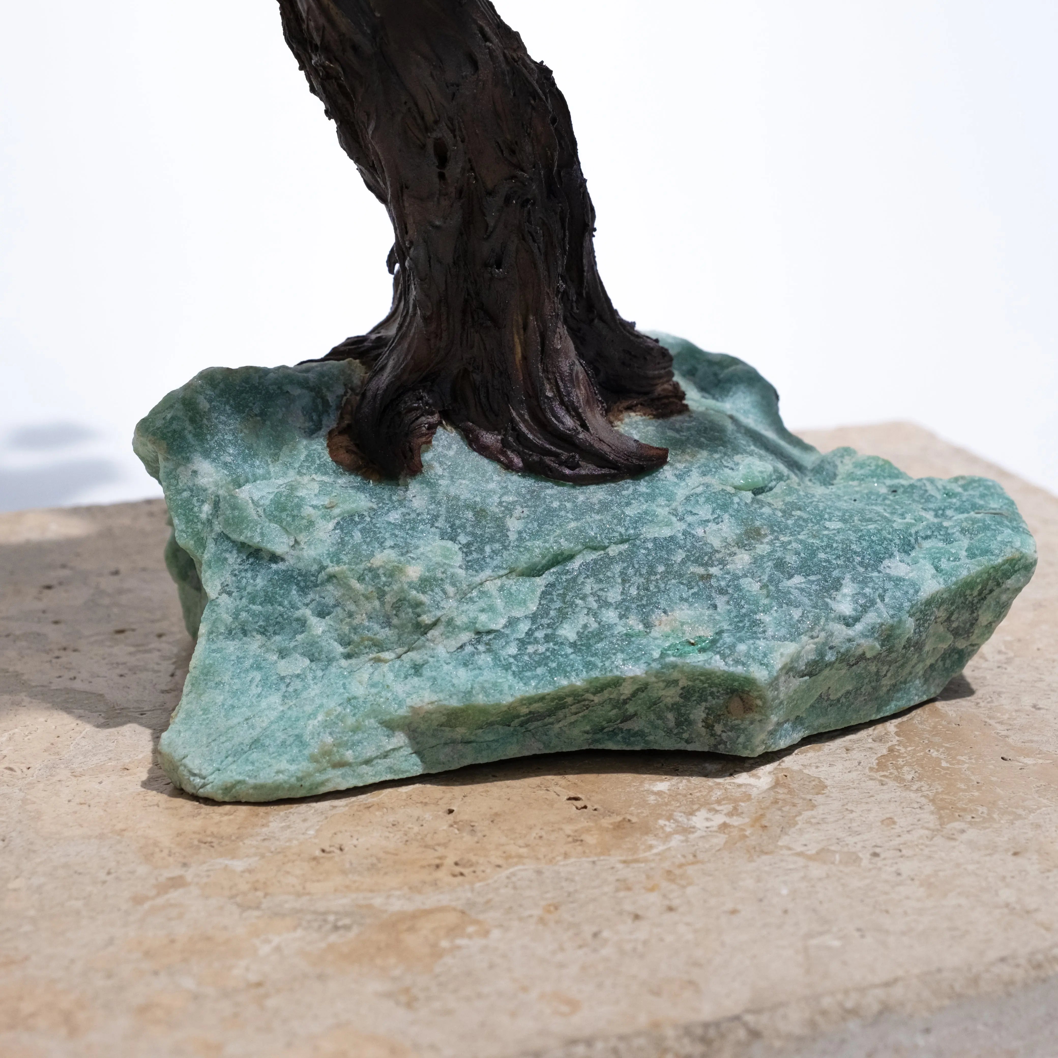 Base details of Aventurine Crystal Bonsai Tree showcasing natural green crystal and wood trunk.