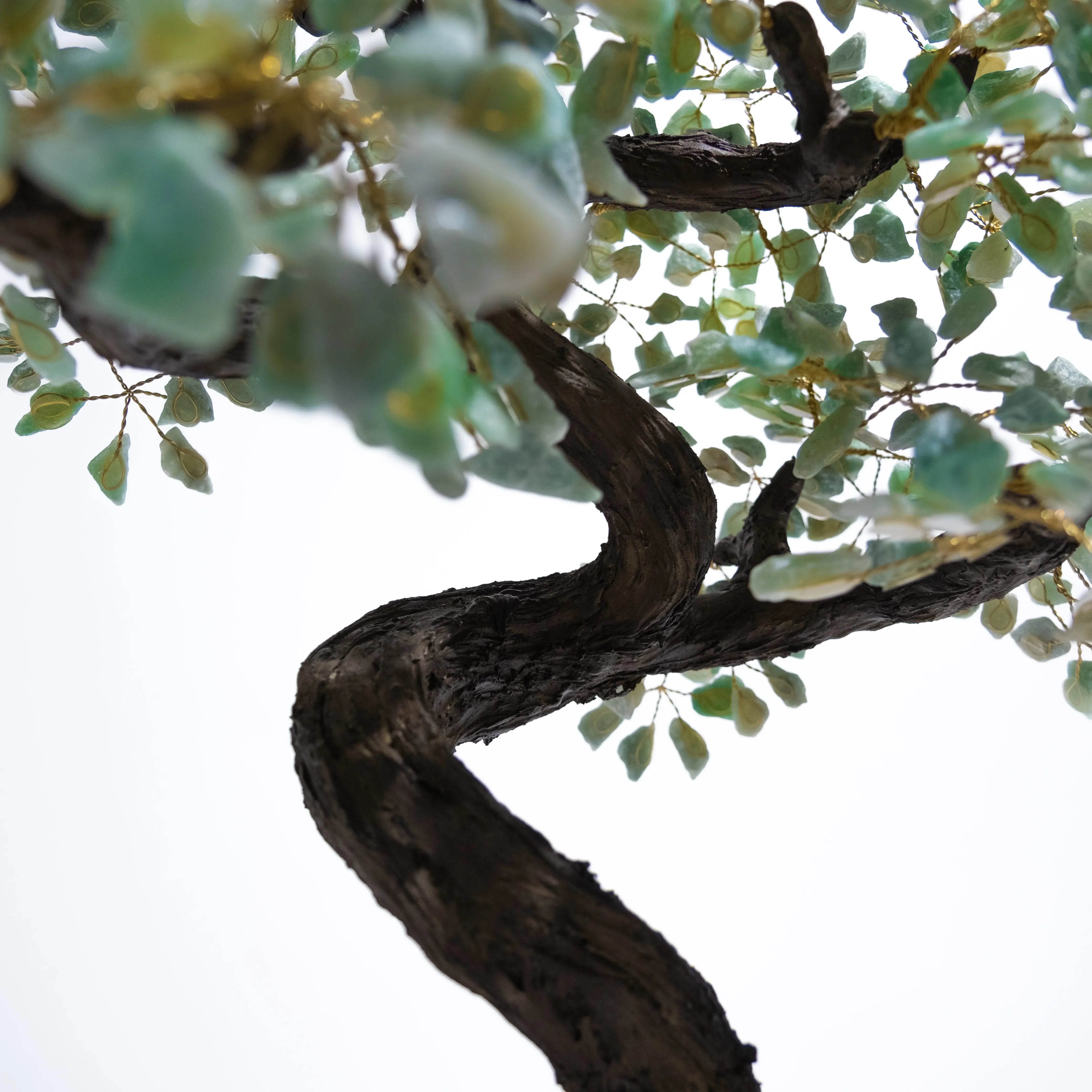 Close-up of a handcrafted Rough Aventurine Crystal Bonsai Tree with textured trunk and green leaves, promoting prosperity and harmony.
