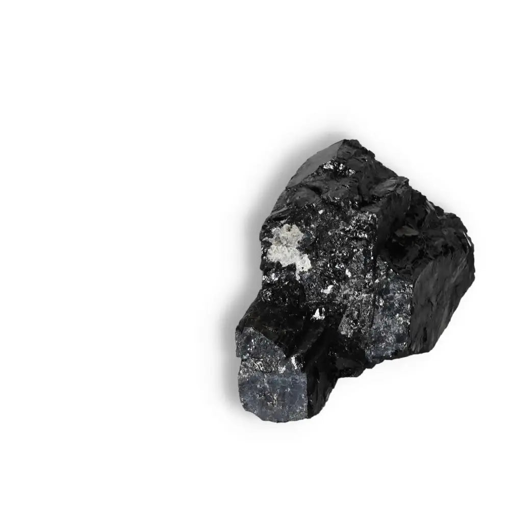 Rough Black Tourmaline Druze L showcasing natural crystal formations on a white background, ideal for energy cleansing and grounding.