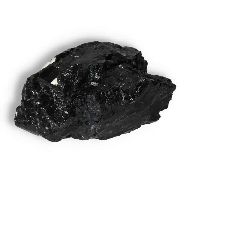 Rough Black Tourmaline Druze L by Sylvia Crystals, known for cleansing and transforming negative energies; spiritual and luxurious.