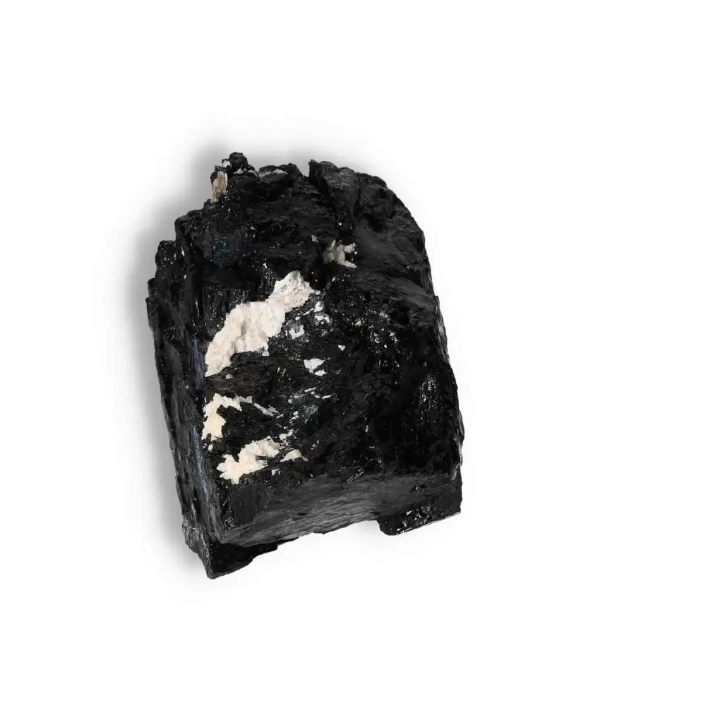 Rough Black Tourmaline Druze crystal from Sylvia Crystals on white background, known for cleansing and transforming energies.