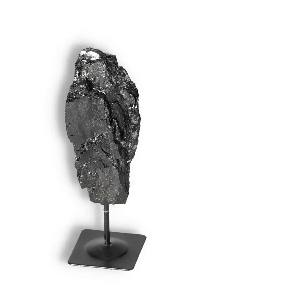 Rough Black Tourmaline on metal stand, premium crystal for cleansing negative energies by Sylvia Crystals.