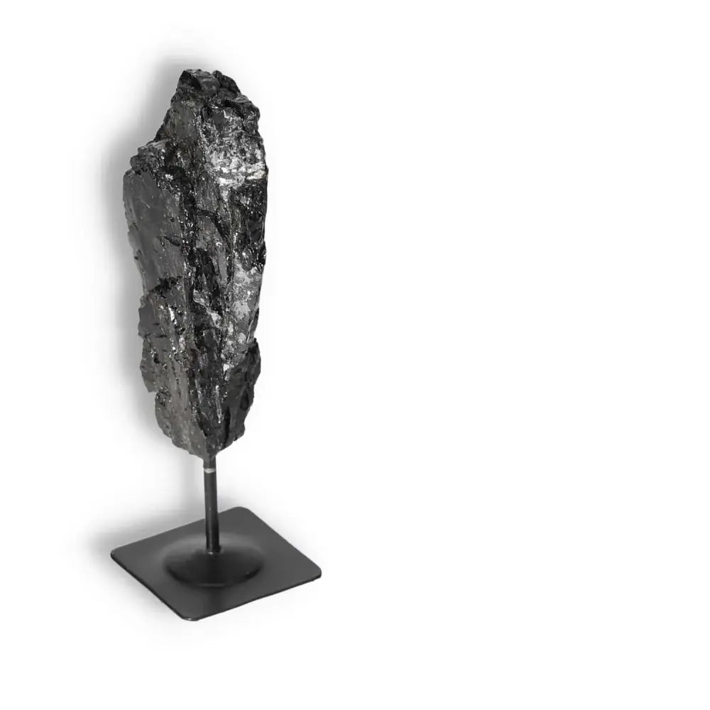 Rough Black Tourmaline with Metal Stand from Sylvia Crystals, premium crystal for cleansing negative energies, on a white background.