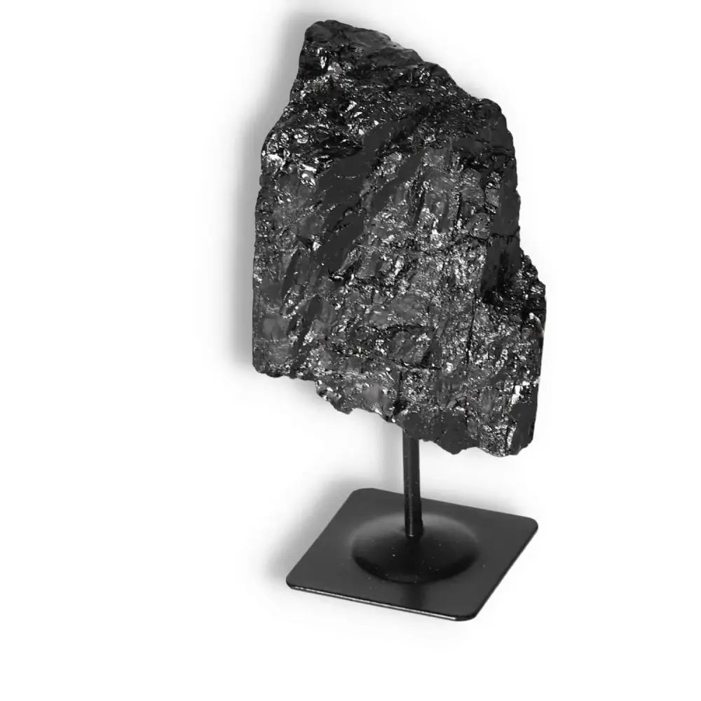 Rough Black Tourmaline on metal stand exuding elegance and energy, ideal for home decor and spiritual healing.