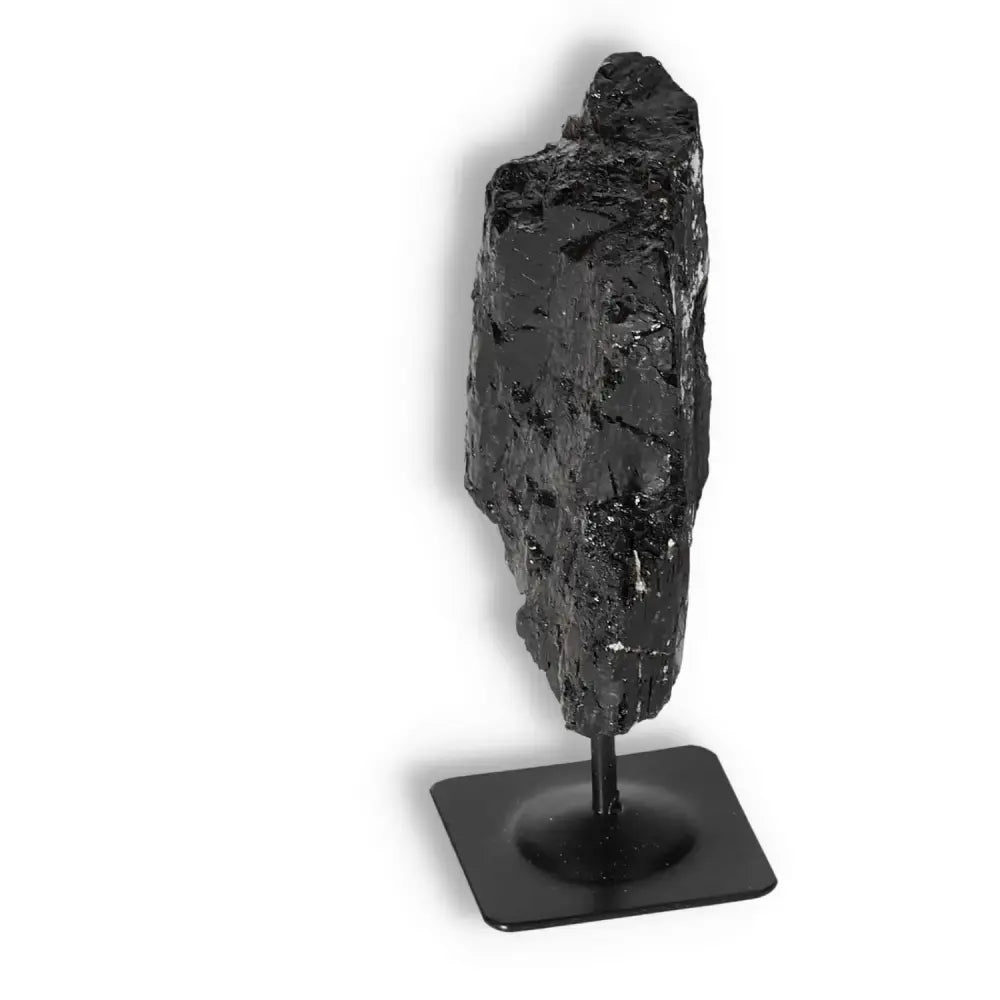 Rough Black Tourmaline with metal stand showcasing elegance and energy cleansing properties from Sylvia Crystals.
