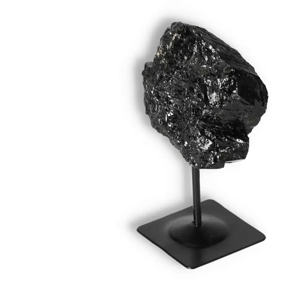 Rough Black Tourmaline with Metal Stand from Sylvia Crystals, showcasing luxury and spiritual grounding properties.