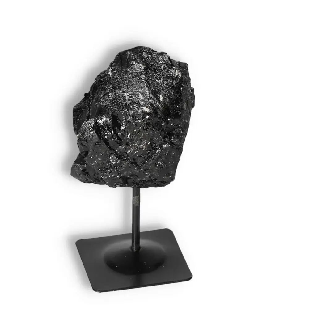 Rough Black Tourmaline on metal stand, ideal for spiritual grounding and cleansing, from Sylvia Crystals' luxury collection.