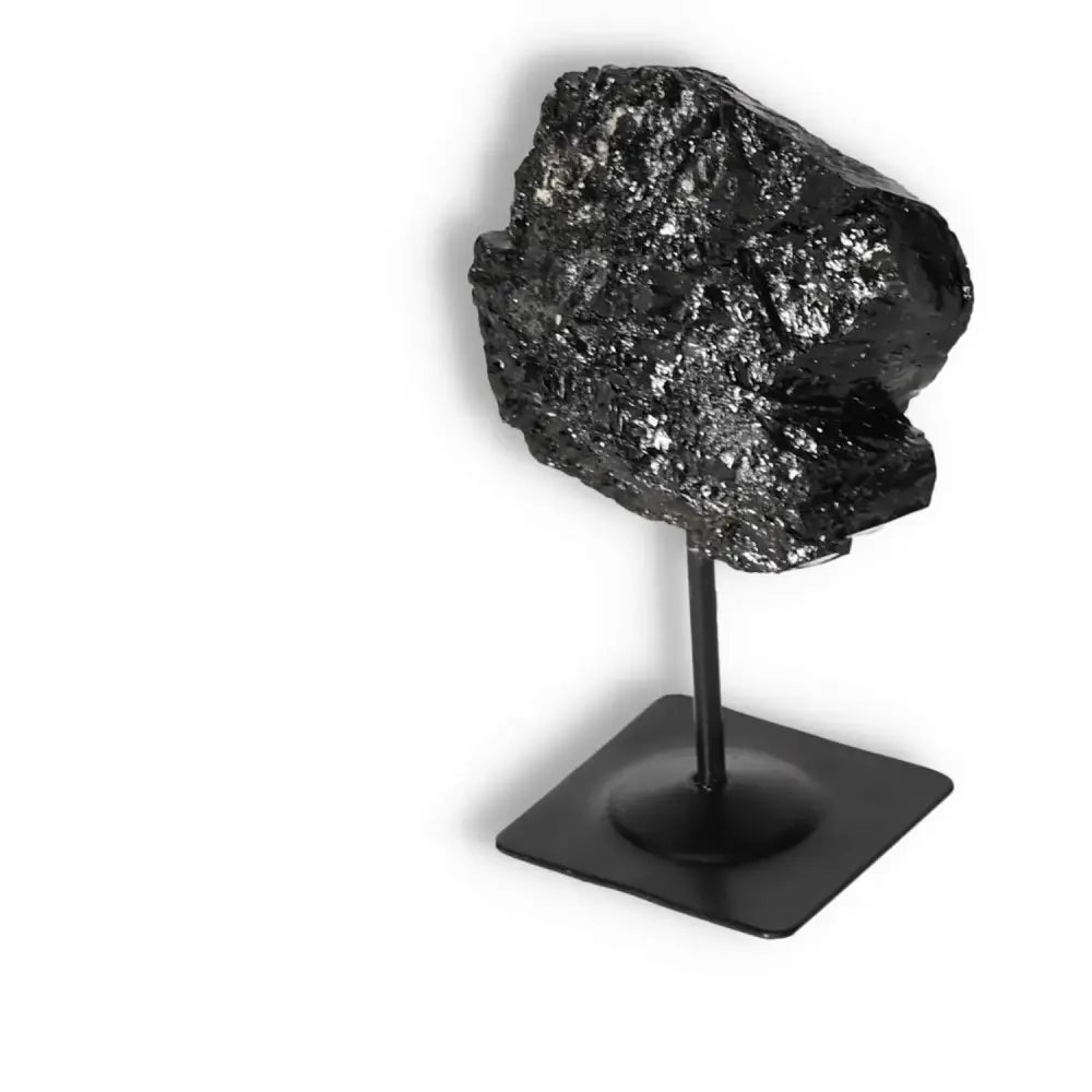 Rough Black Tourmaline on Metal Stand, premium crystal for cleansing and grounding, displayed against a white background.