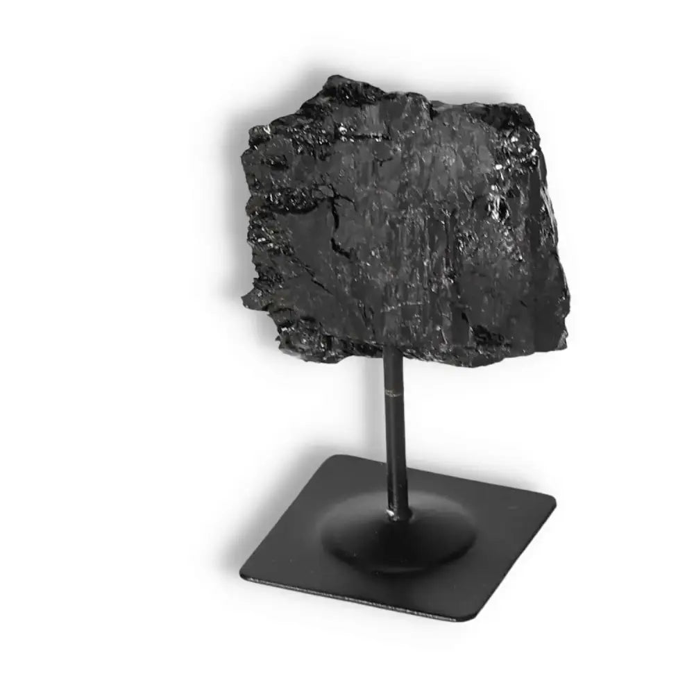 Rough Black Tourmaline with Metal Stand S by Sylvia Crystals, showcasing raw beauty and energy for emotional healing and grounding.