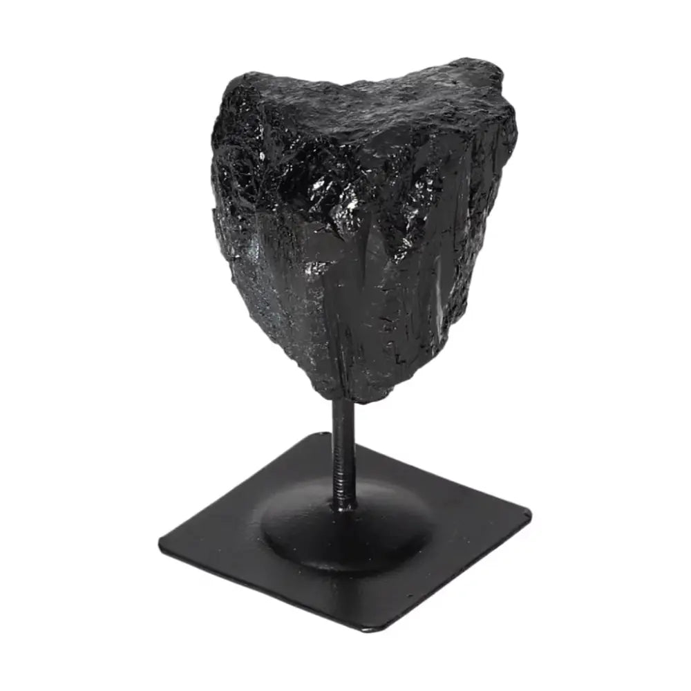 Rough Black Tourmaline on metal stand from Sylvia Crystals, ideal for energy transformation and electromagnetic protection.
