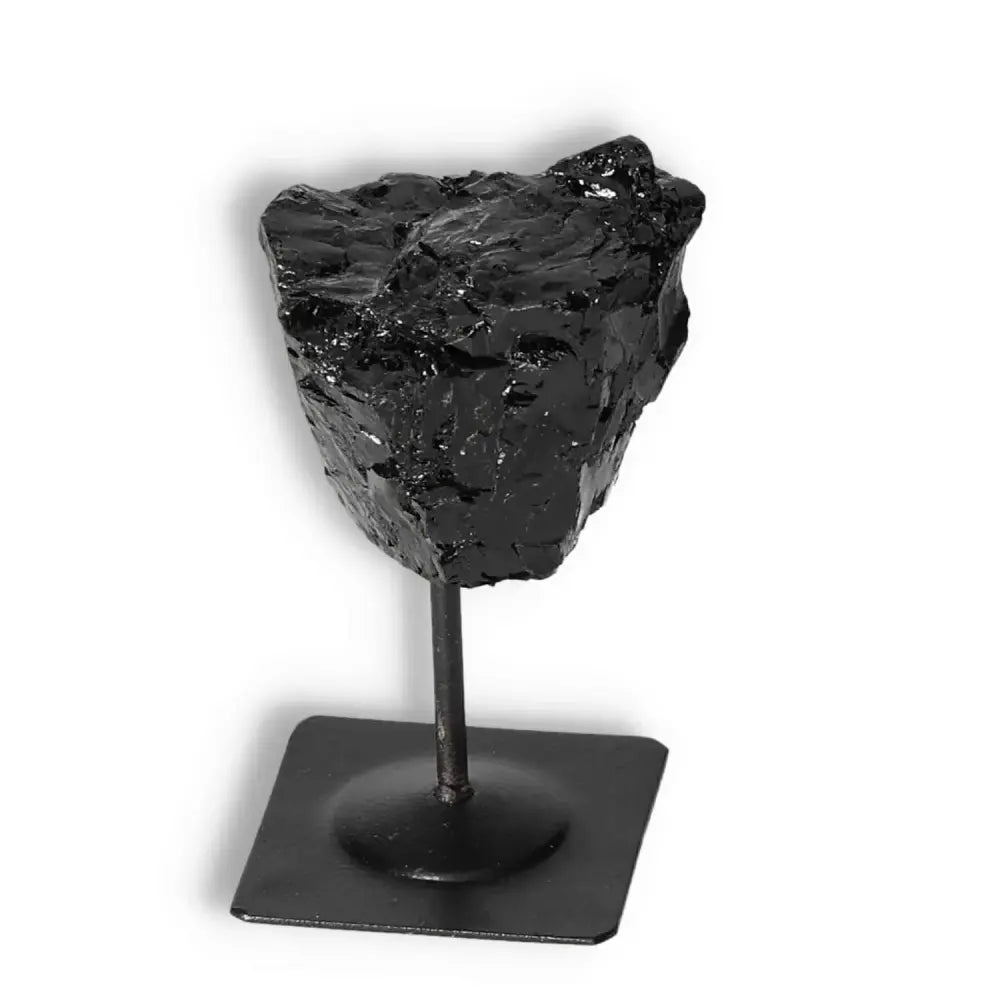 Premium Rough Black Tourmaline on metal stand for energy cleansing by Sylvia Crystals.