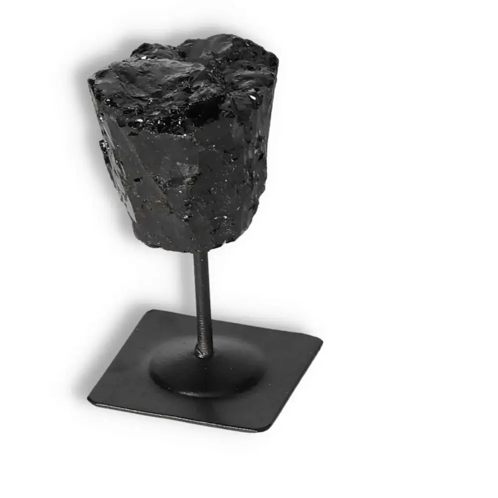 Rough Black Tourmaline with Metal Stand S, a healing crystal from Sylvia Crystals for cleansing and transforming negative energies.