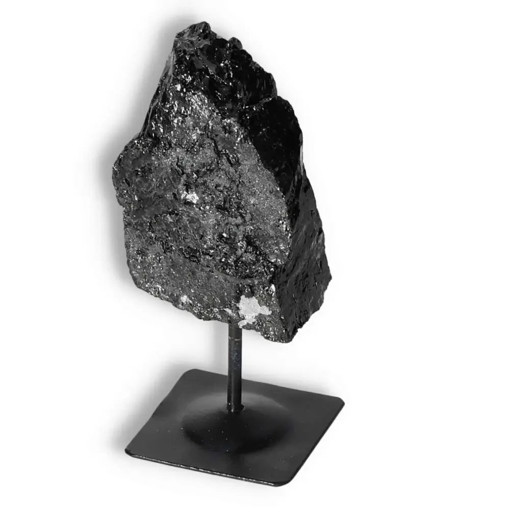 Rough Black Tourmaline on metal stand, enhances emotional wellness and dispels negative energy, Sylvia Crystals.
