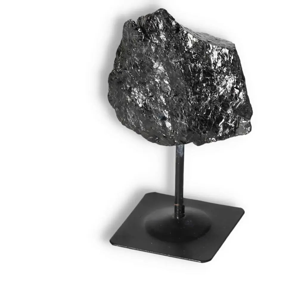 Rough Black Tourmaline on a Metal Stand by Sylvia Crystals; a blend of natural artistry and spiritual depth for conscious luxury.