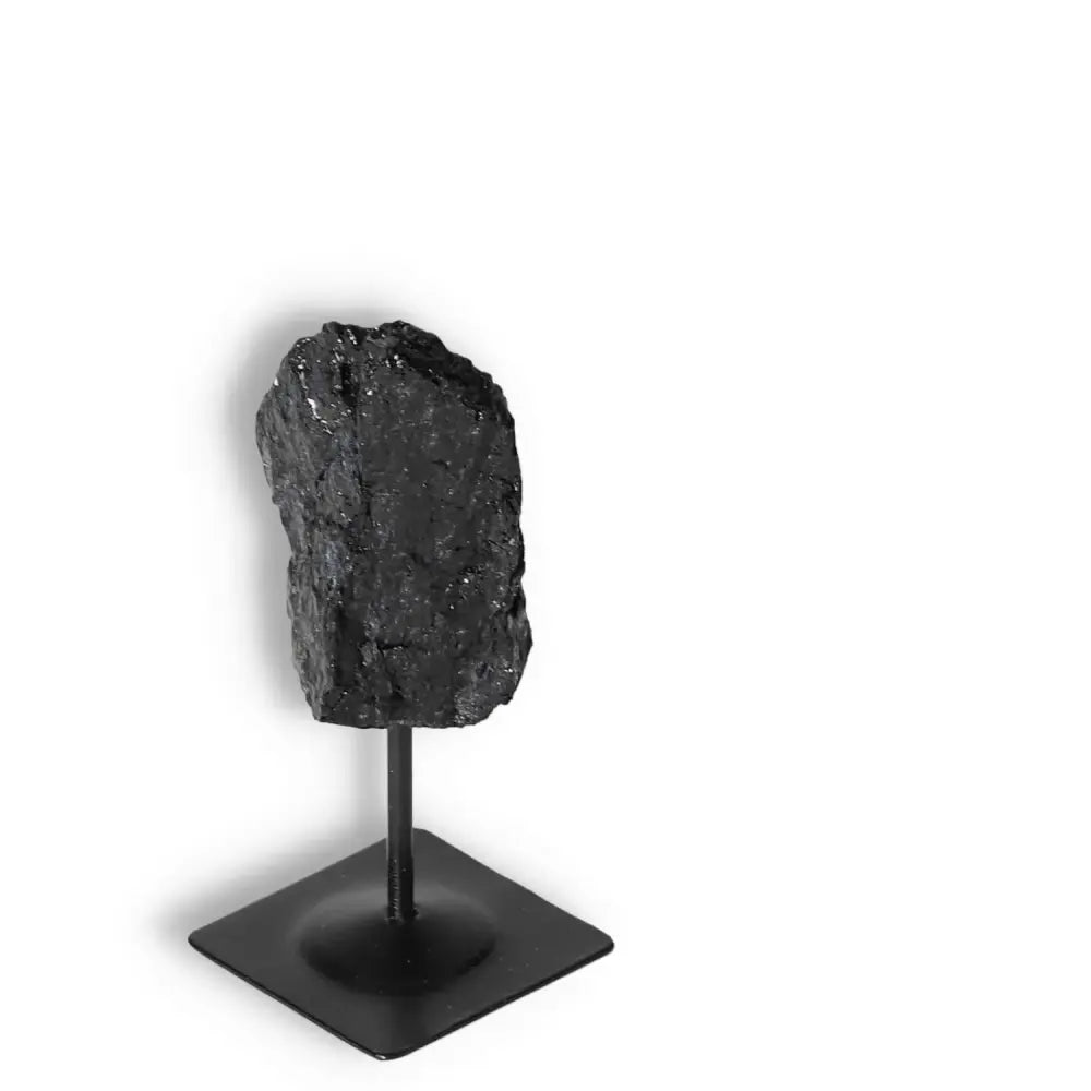 Rough Black Tourmaline on metal stand from Sylvia Crystals, exemplifying elegance and luxury while providing grounding energy.