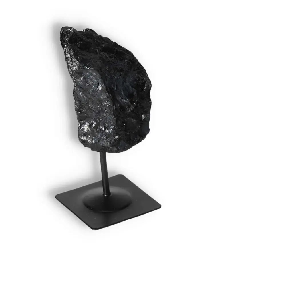 Rough Black Tourmaline with Metal Stand for energy cleansing and grounding, from Sylvia Crystals.