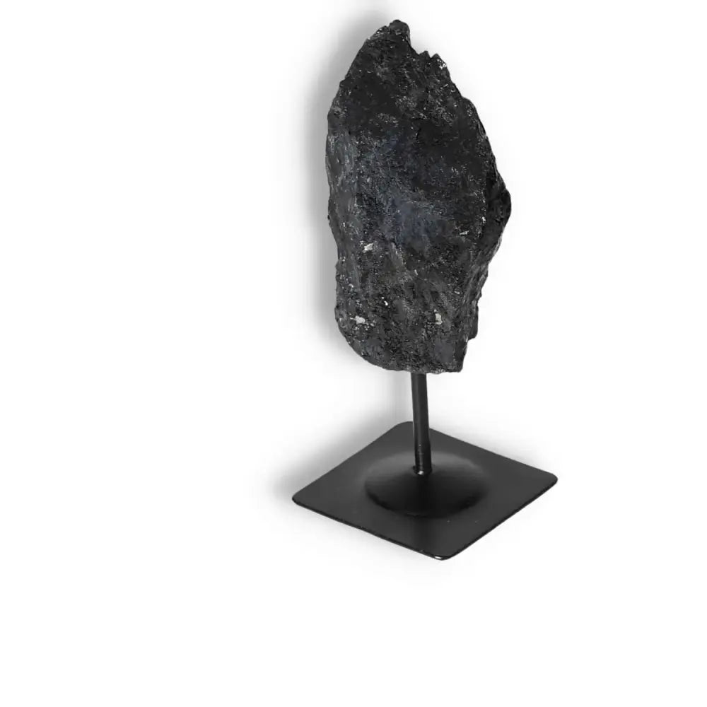 Rough Black Tourmaline on metal stand, showcasing its raw elegance and energy-cleansing properties, from Sylvia Crystals' premium collection.