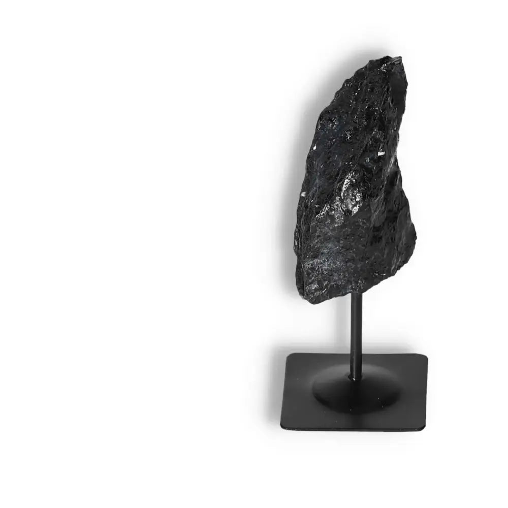 Rough Black Tourmaline on metal stand from Sylvia Crystals, known for cleansing and grounding energies, luxury decor item.