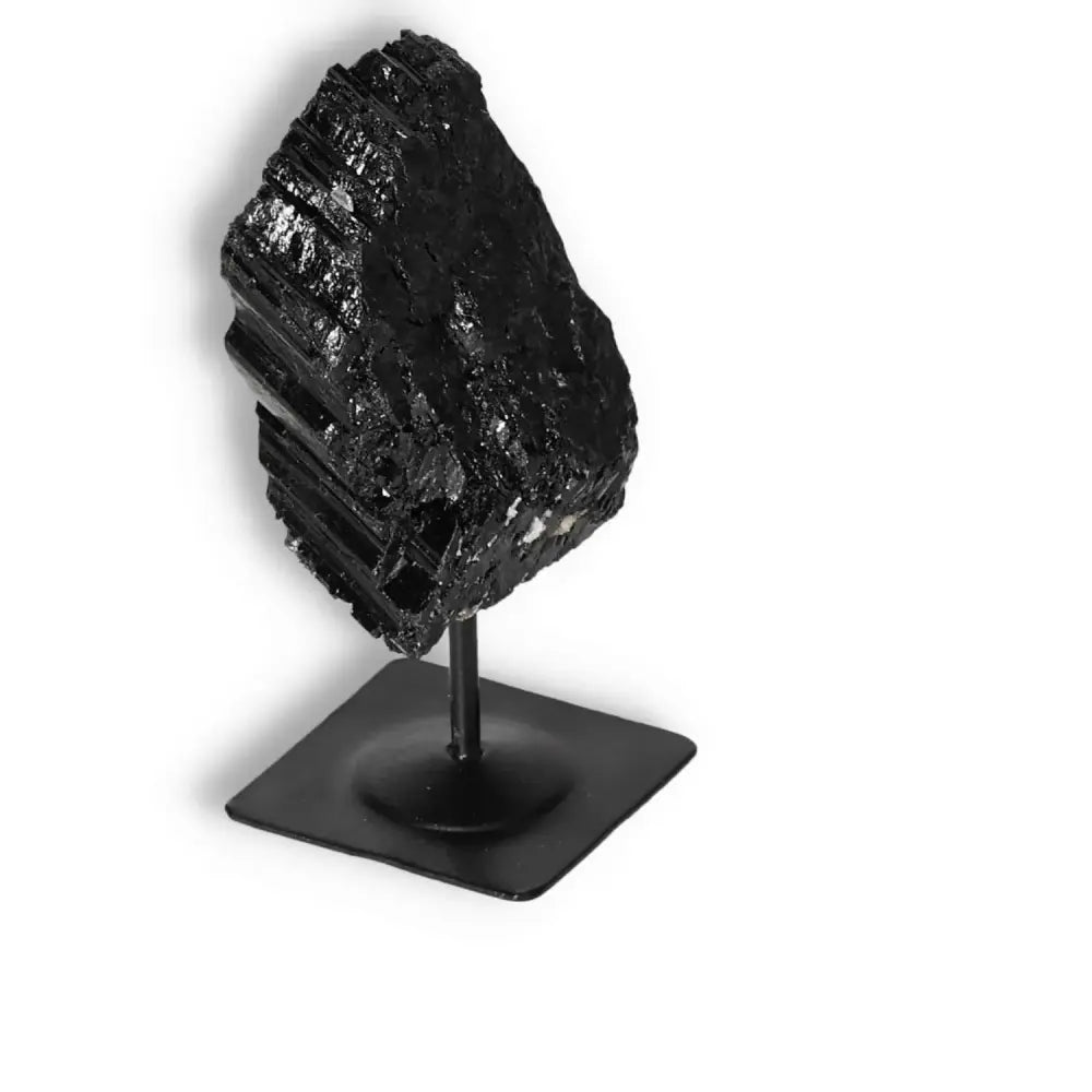 Rough Black Tourmaline on Metal Stand from Sylvia Crystals, known for neutralizing negative energies and enhancing decor elegance.