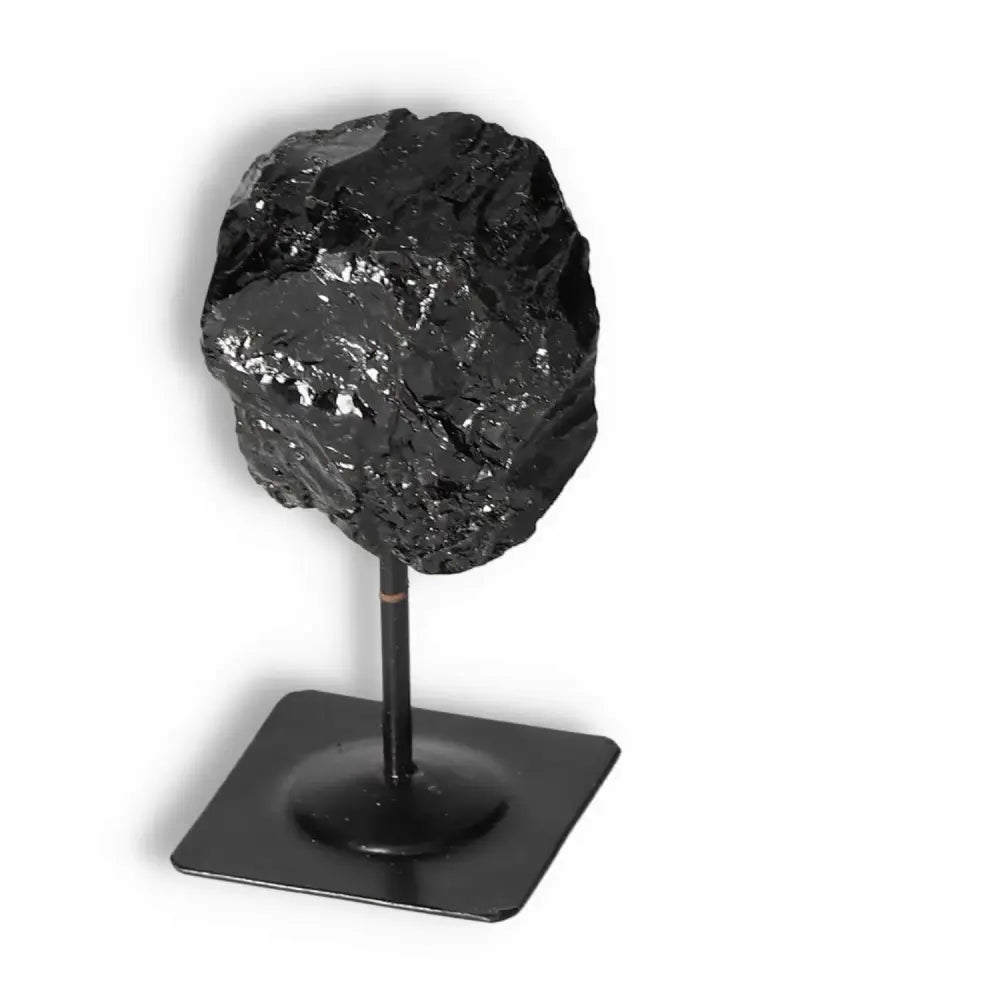 Black Tourmaline gemstone on metal stand, premium luxury crystal from Sylvia Crystals, known for energy-cleansing properties.