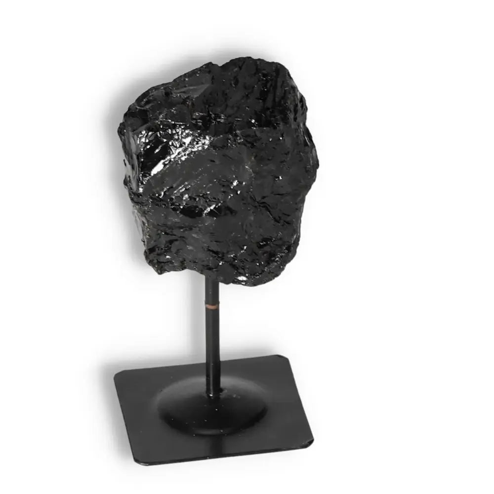 Rough Black Tourmaline on metal stand, premium energy-cleansing gemstone from Sylvia Crystals.