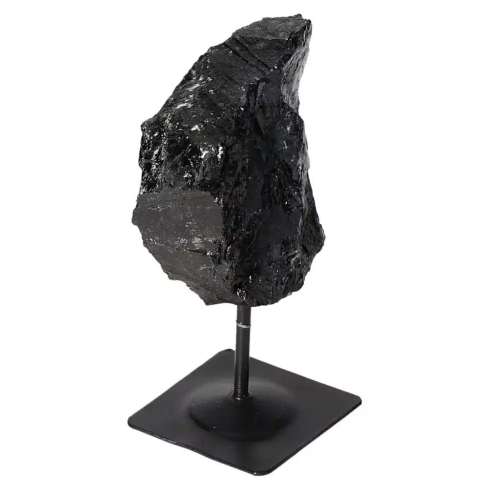 Rough Black Tourmaline with Metal Stand S from Sylvia Crystals, a healing stone for grounding and cleansing negative energies.