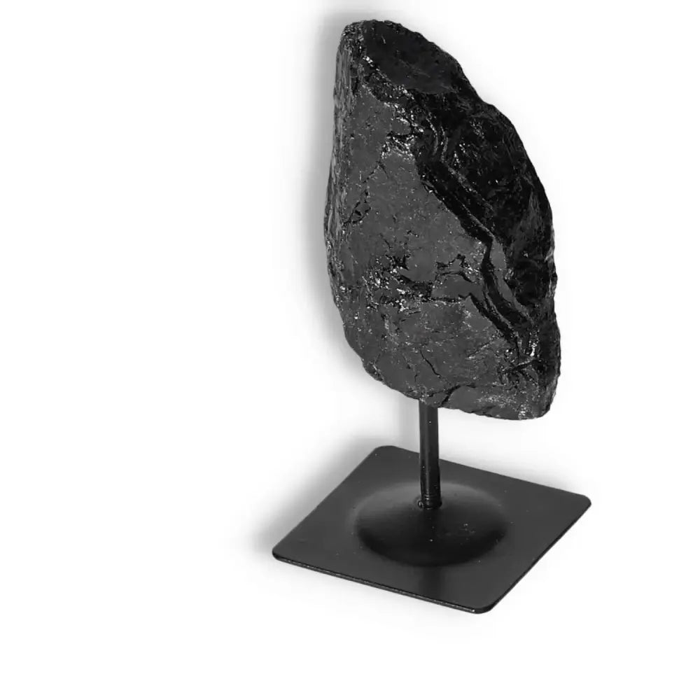 Rough Black Tourmaline Crystal on Metal Stand S by Sylvia Crystals, known for cleansing and transformation, dispels negative energy.