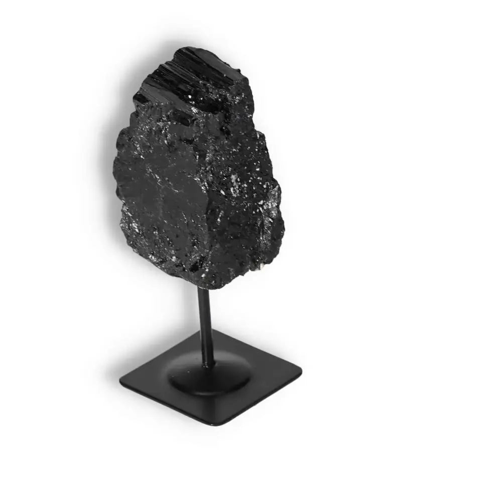 Rough Black Tourmaline on metal stand from Sylvia Crystals, ideal for energy cleansing and decor.