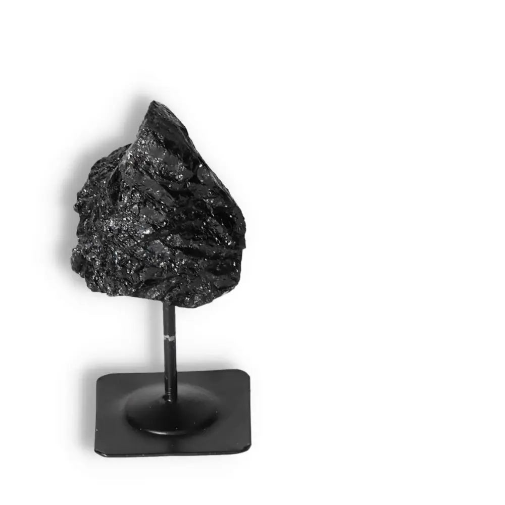 Premium Rough Black Tourmaline on Metal Stand for energy cleansing, from Sylvia Crystals. Enhance your spiritual journey.
