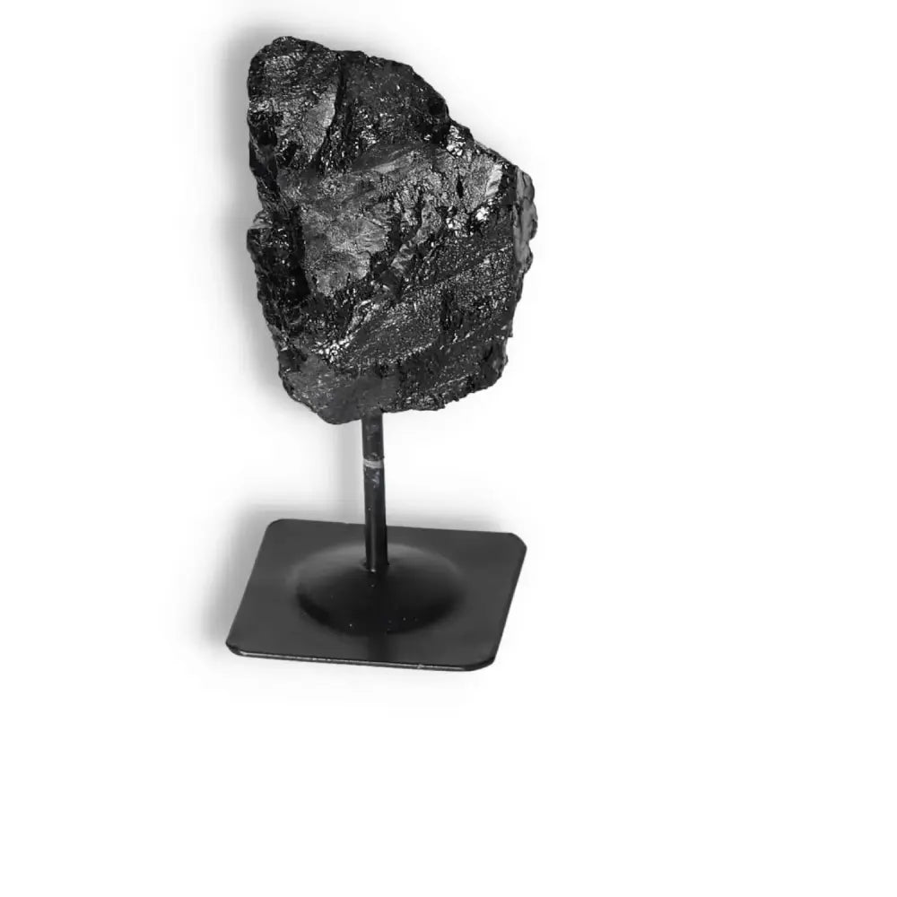 Rough Black Tourmaline on metal stand, enhances energy and decor from Sylvia Crystals, known for cleansing negative energies.