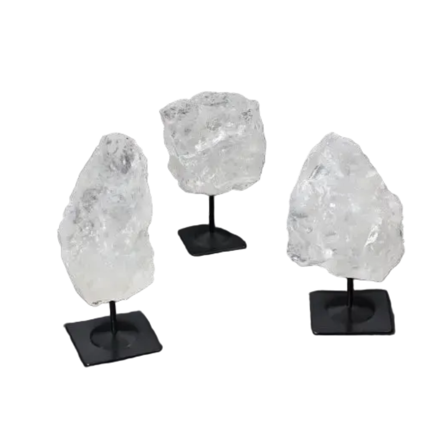 Three rough clear quartz crystals on metal stands, used for purification and harmonizing, displayed on a dark background.