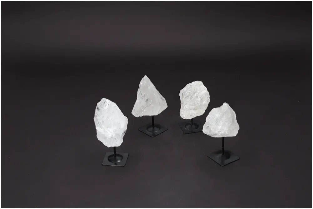 Rough Clear Quartz stones on metal stands for purification and energy harmonization, ideal for absorbing negative vibrations and EMFs.