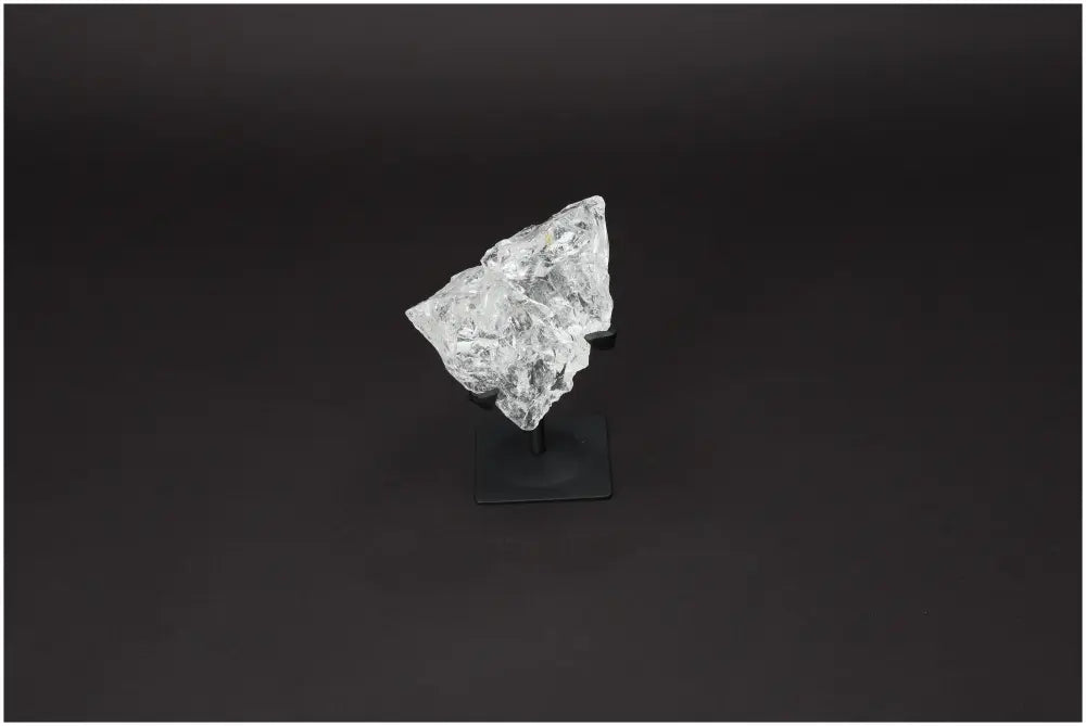 Rough Lemurian Quartz on metal stand, featured product from Sylvia Crystals known for purification and well-being enhancement.